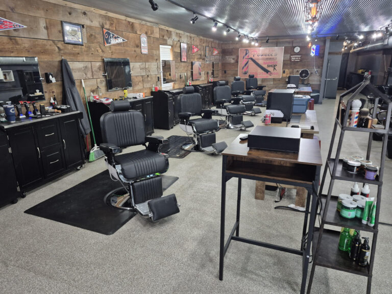 Barber chairs and wood-lined interior at Powell’s Barber Shop in Silvis